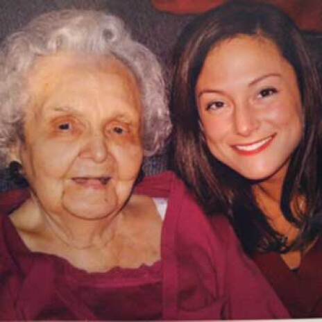 A woman with an elderly woman smiling at the camera