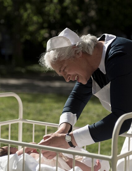 An actor, seen here, is portraying a nurse caring for a child diagnosed with jaundice.