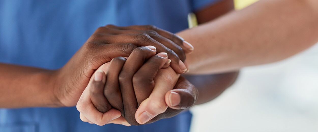 Image of two sets of hand clasped together