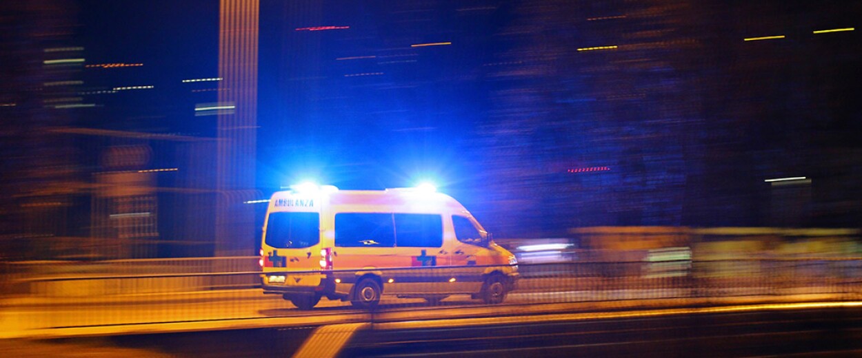 European ambulance driving away in the night