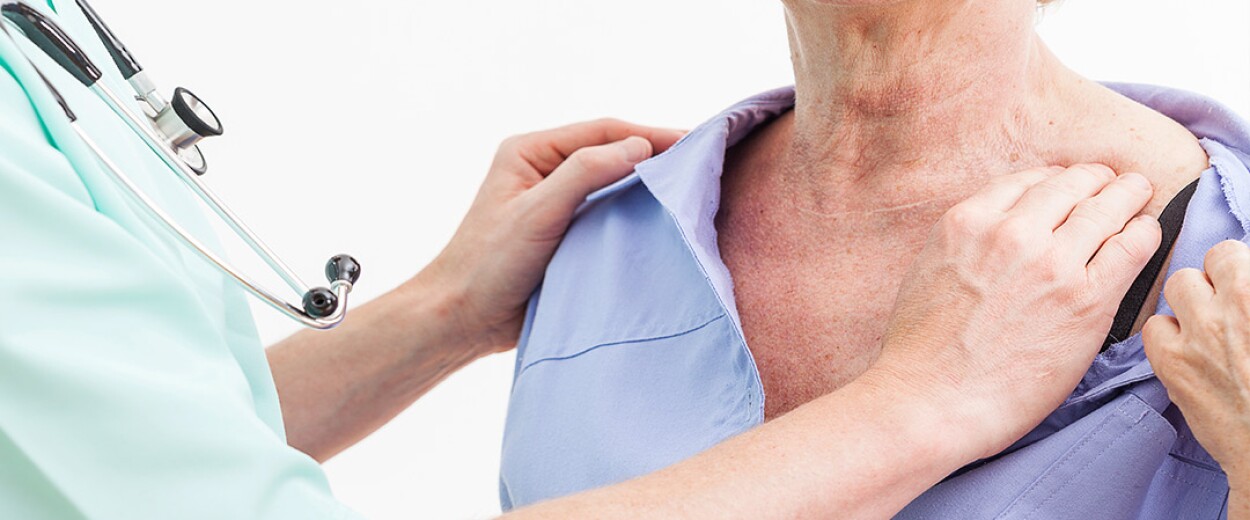 Medical personnel inspecting a patient's collarbone