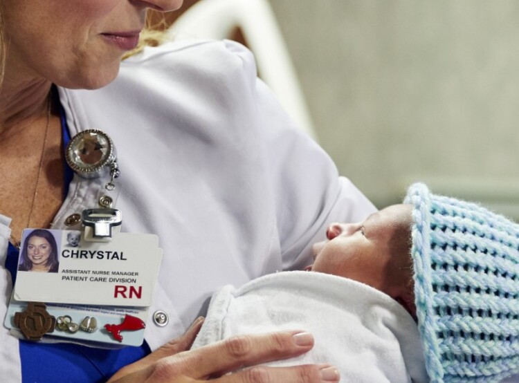 Close-up of female nurse holding newborn baby