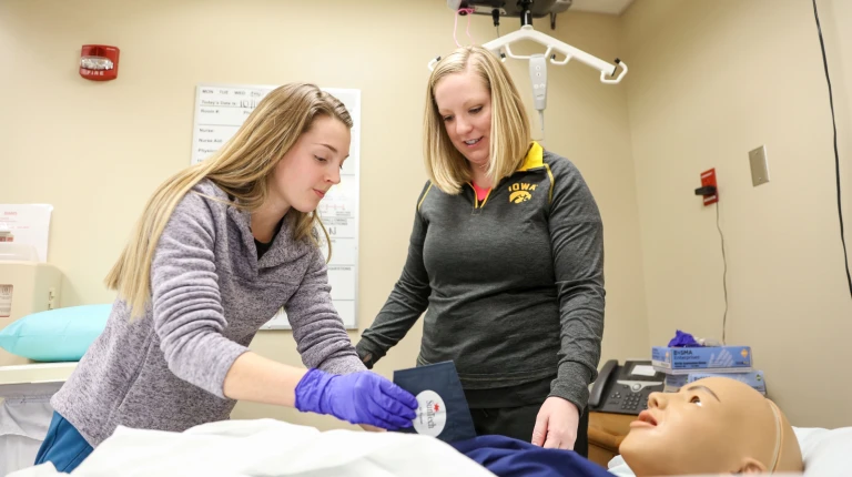 image of nursing student and instructor training on mannequin as part of the Iowa Online Nurse Residency Program (IONRP) for training rural nurses