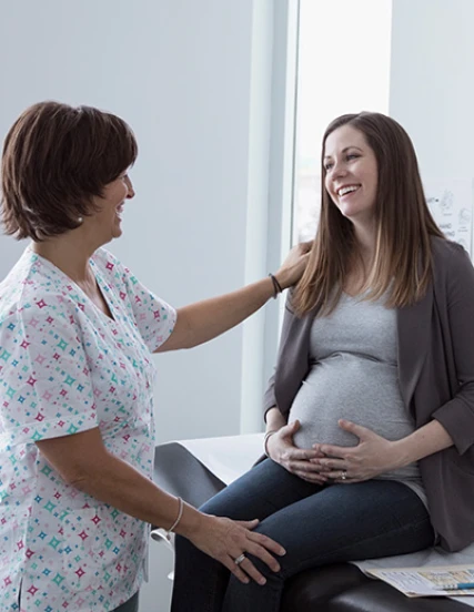 An obstetrics and gynecology nurse attends to a pregnant patient