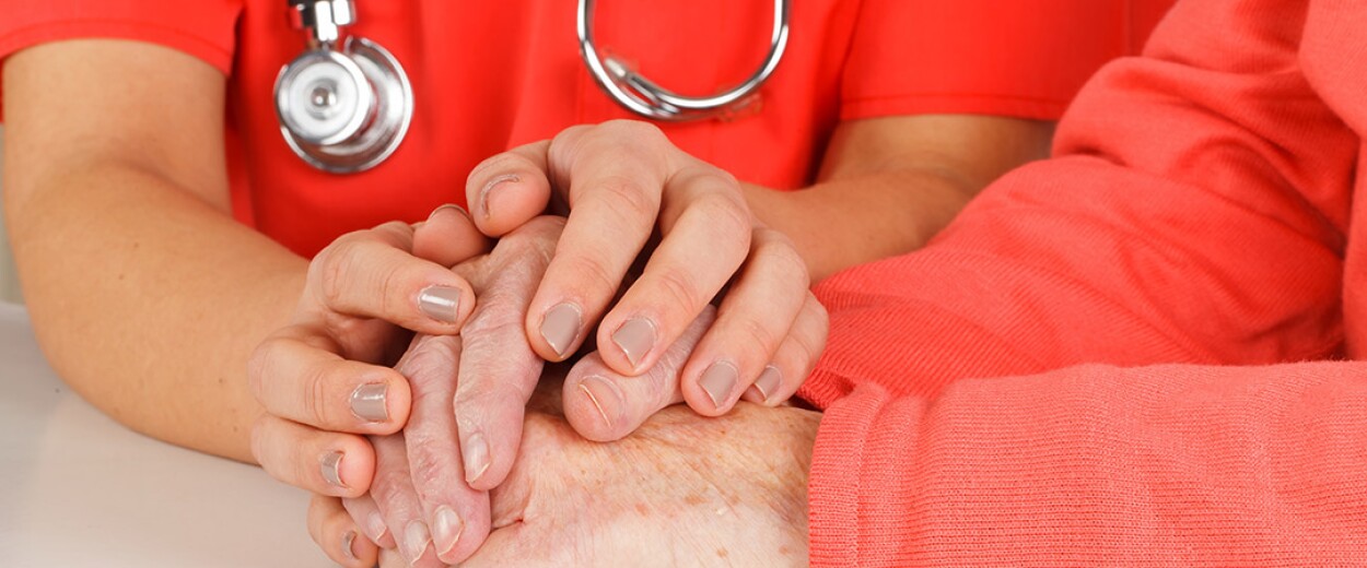 Close up of two pairs of hands clasping one another