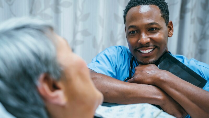 male nurse smiling with patient
