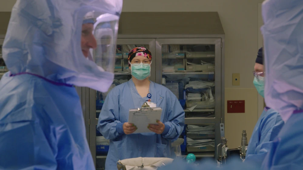 OR nurse with surgical team in PPE