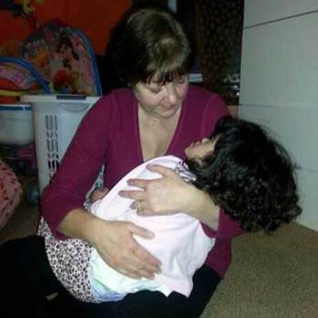 Image of woman cradling her daughter